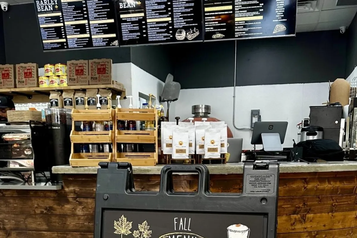 Barley Bean coffee counter with overhead menu boards, roasted bean bags and espresso machines