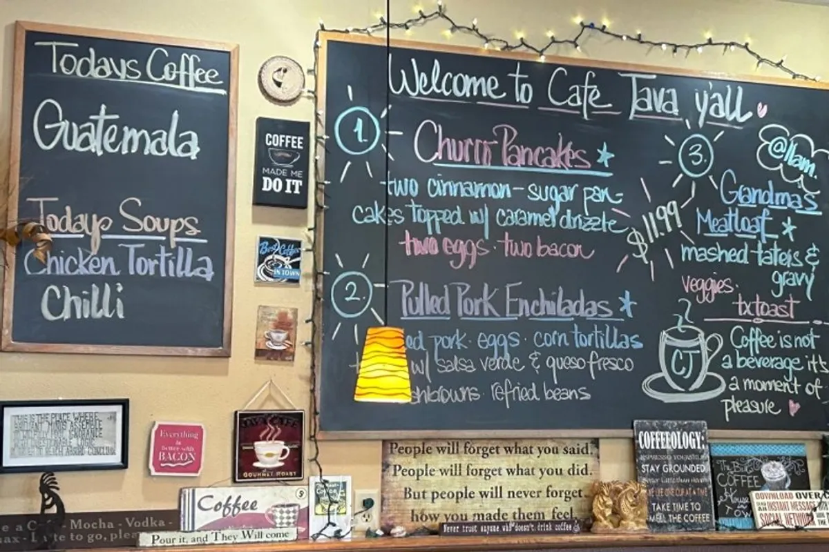 Cafe Java wall of chalkboard menus, string lights and signs above the counter