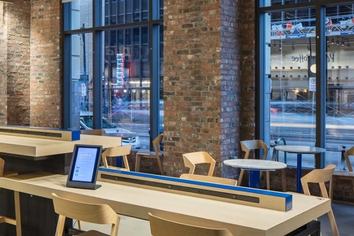 Capital One Café Downtown Austin interior with wood counter, high stools, brick columns and storefront windows